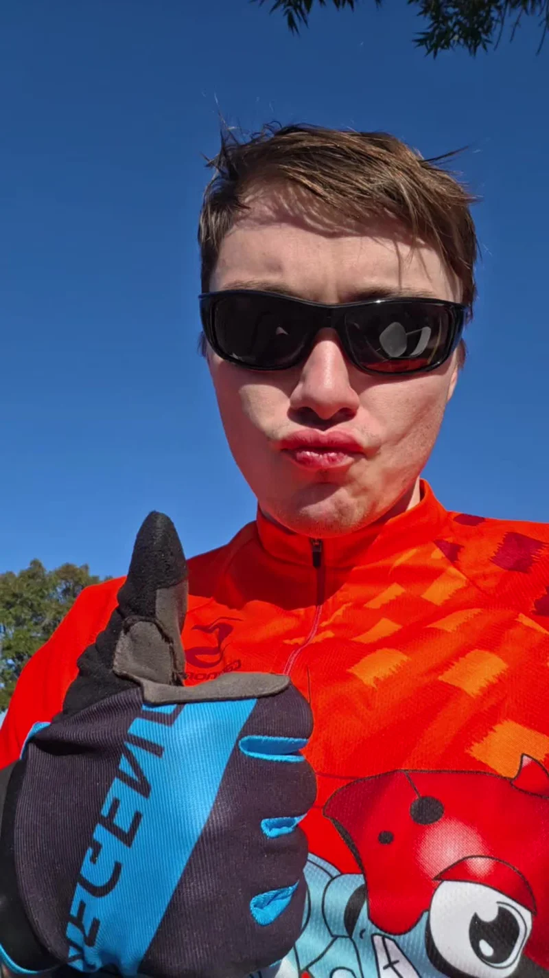 Jaiven gives a thumbs-up in an orange fox cycling jersey at Foxy’s Fall Century